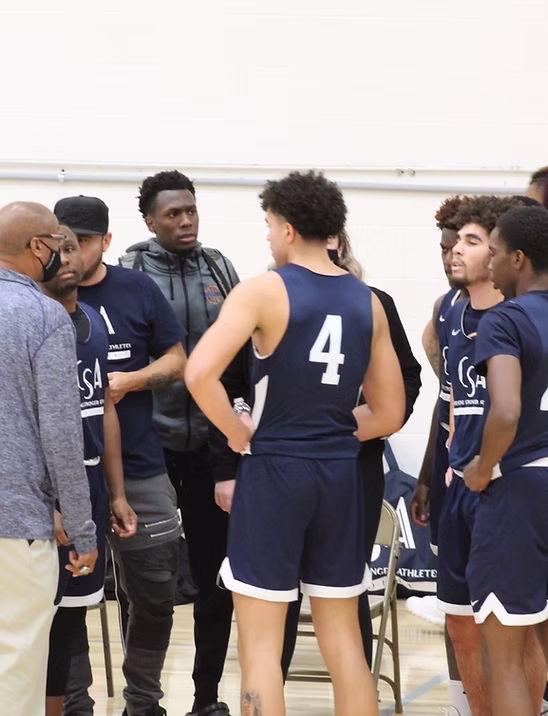 Players gathered with their coach during a basketball team discussion